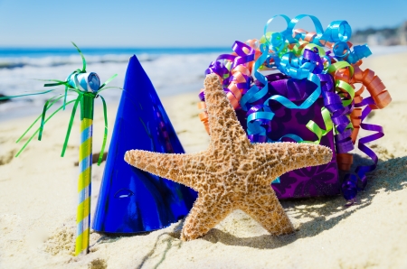 Birthday decorations on the sandy beach by the oceanの写真素材