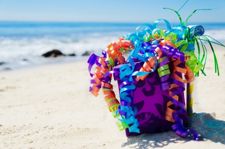 Birthday decorations on the sandy beach by the oceanの写真素材