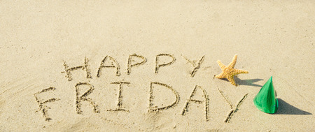 Sign "Happy Friday" with starfish on the sandy beach の写真素材
