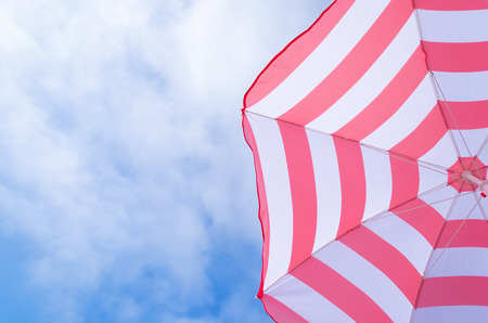 Beach umbrella's background against a blue skyの写真素材