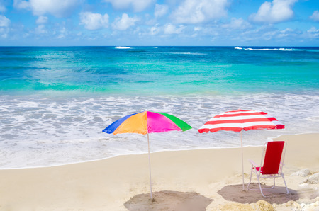 Color Beach umbrellas and chair by the ocean in sunny dayの写真素材