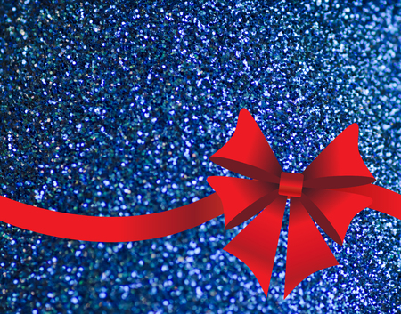 Blue sparkling holiday's background with red bowの写真素材