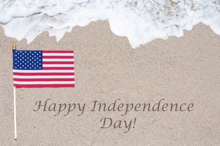 Happy Independence Day USA background with flag on the sandy beach (4th of july holiday concept)の写真素材