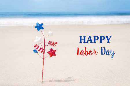 Labor Day USA background with decoration on the sandy beach