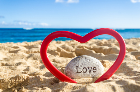 Sign love with heart on the sandy beach near ocean in Hawaii, Kauai - Valentine's day romantic conceptの写真素材
