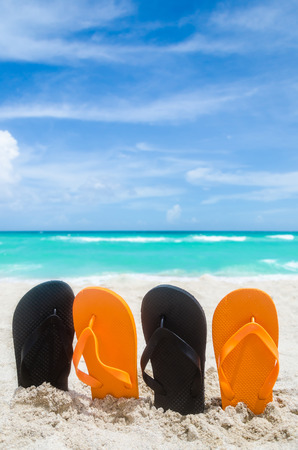 Ocean Halloween background with orange and black flip flopsの写真素材