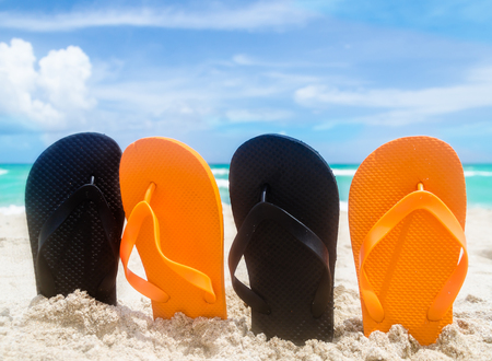 Ocean Halloween background with black and orange flip flopsの写真素材