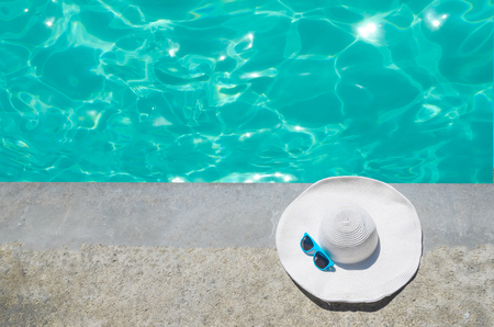 White summer hat near the swimming poolの写真素材