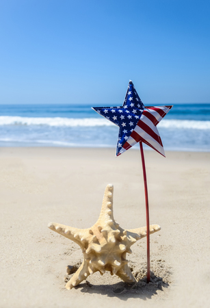 Patriotic USA background with starfish decorations on the sandy beachの写真素材