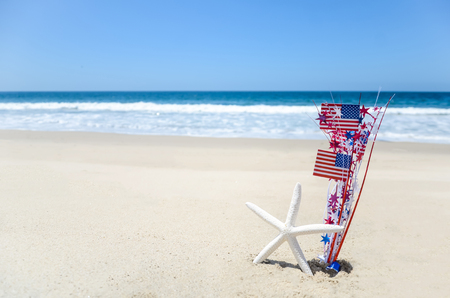 Patriotic USA background with starfish amd decorations on the sandy beachの写真素材