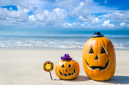 Halloween pumpkin background on the sandy beach near the ocean の写真素材