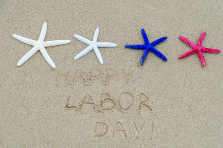 Happy Labor day background with starfishes on the sandy beachの写真素材