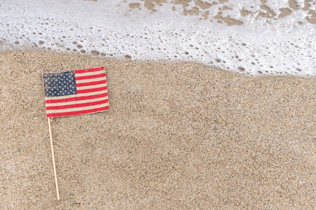 Patriotic USA background with flag on the sandy beachの写真素材