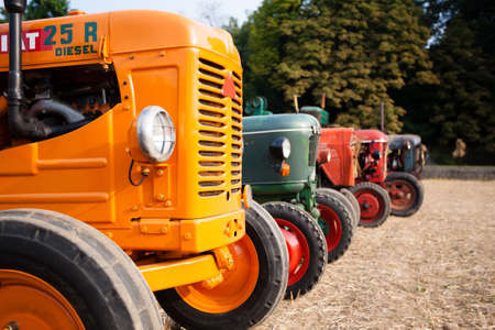 Five old tractors in perspective, agricultural vehicle, rural life