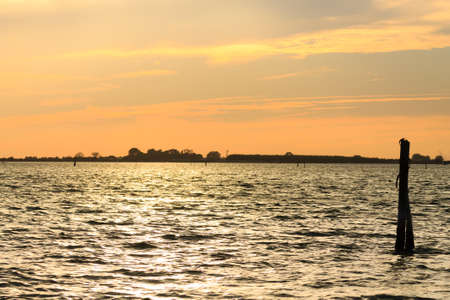 Sunset over water from "Delta del Po", Italian landscape. water and skyの写真素材