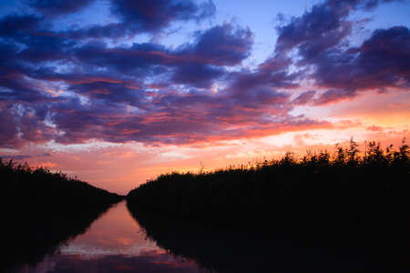 Sunset over water from "Delta del Po", Italian landscape. water and skyの写真素材