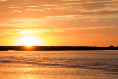 Sunset over water from "Delta del Po", Italian landscape. water and skyの写真素材