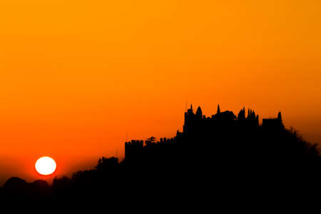 Castle silhouette at sundown. Italian panorama from "Marostica". Orange skyの写真素材