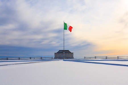 Winter panorama from Italian Alps. First world war memorial building. Italian flag wavingの写真素材