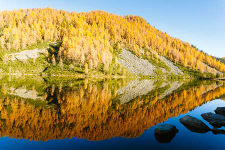 Mountain panorama from Italian Alps. Reflections on water from "Calaita" lake. Beautiful dolomitesの写真素材