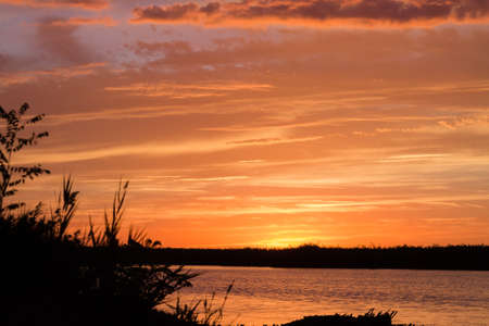 Sunset over water from "Delta del Po", Italian landscape. water and skyの写真素材