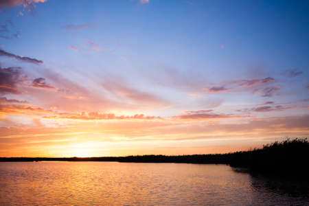 Sunset over water from "Delta del Po", Italian landscape. water and skyの写真素材