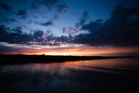 Sunset over water from "Delta del Po", Italian landscape. water and skyの写真素材