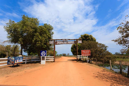 Pantanal entrance gate along Transpantaneira dirt road. Brazilian landmark. Road in perpectiveの写真素材