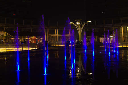 MILAN, ITALY-OCTOBER 30, 2016: Financial district night view. Illuminated water fountains. Modern skyscrapers in Gae Aulenti square. Unicredit bank towerのeditorial素材