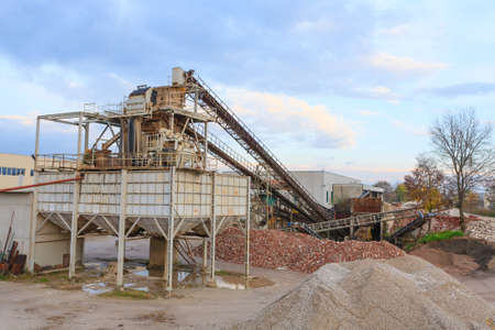 Stone quarry with silos and conveyor belts. Industrial equipment. Mining