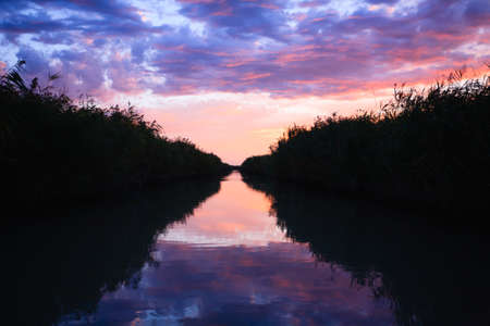 Sunset over water from "Delta del Po", Italian landscape. water and skyの写真素材