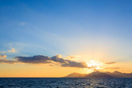 Sunset from the port of Cannes, France. Beautiful french panorama. Sun over Esterel mountains