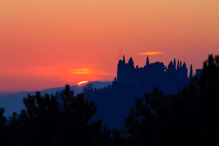 Castle silhouette at sundown. Italian panorama from "Marostica". Orange skyの写真素材