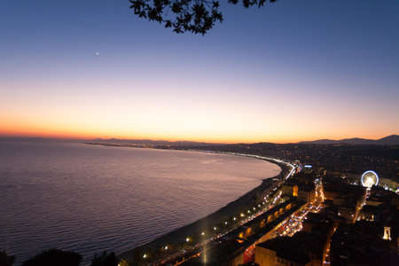 Nice beach night landscape, France.  Nice beach and famous Walkway of the English, Promenade des Anglais. Famous French touristic townの写真素材
