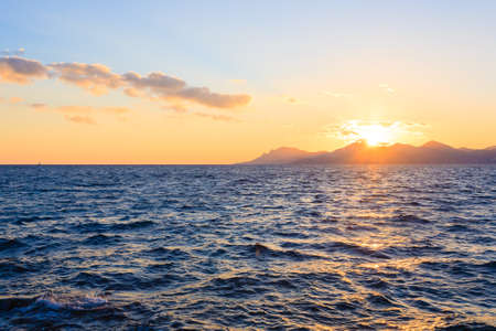 Sunset from the port of Cannes, France. Beautiful french panorama. Sun over Esterel mountainsの写真素材