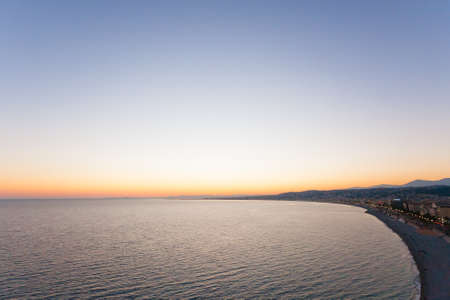 Nice beach day landscape, France.  Nice beach and famous Walkway of the English, Promenade des Anglais. Famous French touristic townの写真素材