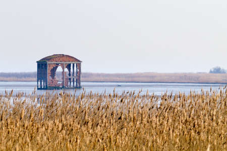 Old abandoned warehouse inside Po river lagoon. Italian panoramaの写真素材