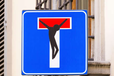 Road sign with a crucified man, street art, metropolitan artの写真素材