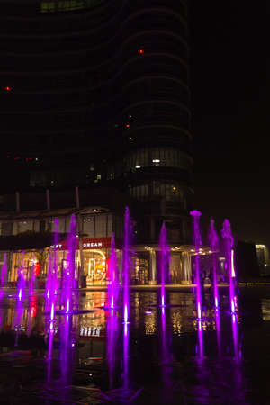 MILAN, ITALY-OCTOBER 30, 2016: Financial district night view. Illuminated water fountains. Modern skyscrapers in Gae Aulenti square. Unicredit bank towerのeditorial素材