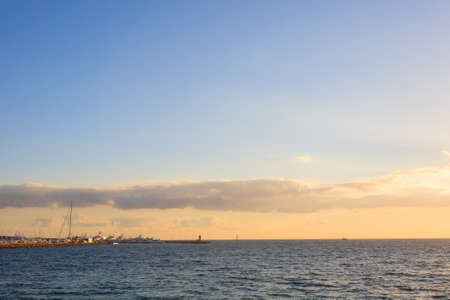 Sunset from the port of Cannes, France. Beautiful french panorama. Sun over Esterel mountainsの写真素材