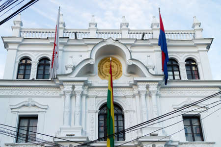 Government building facade view, Sucre, Bolivia. Bolivian flagの写真素材