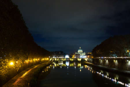 Night scene of Rome, Tevere river with Saint Peter basilica in background. Italian landmarkの写真素材