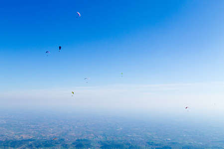 Paraglider on blue sky. Borso del Grappa, famous paragliding site, Italy