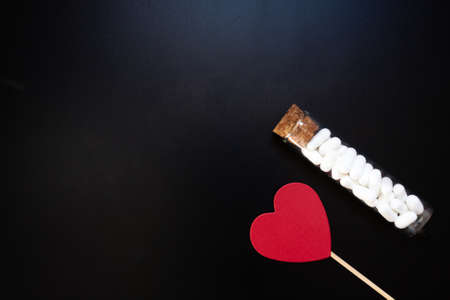 Jordan almonds and heart shape. Wedding decoration on black backgroundの写真素材