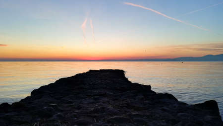 Sunset at Garda lake, Italy. Italian landscape. Pier in perspective