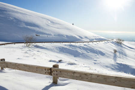Winter landscape, curves road with snow. Mount Grappa landscape, Italyの写真素材