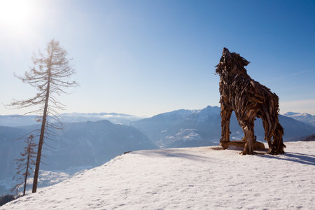 Wooden sculpture of a wolf made of tree branches. Vaia tempest wolf