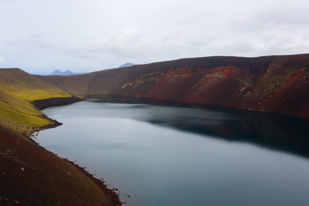 Volcanic crater with water near Landmannalaugar area, Iceland. Colored mountains