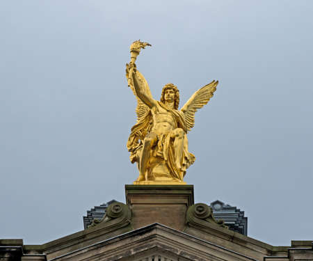 Sitting golden angel on the top of historic house in Dresdenの写真素材