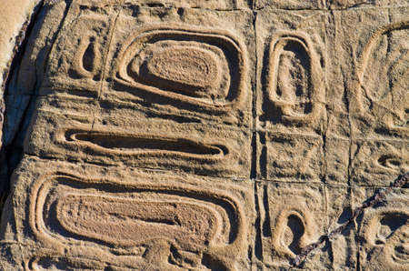 Strange designs on the rocks formed by the erosion of wind and waterの写真素材